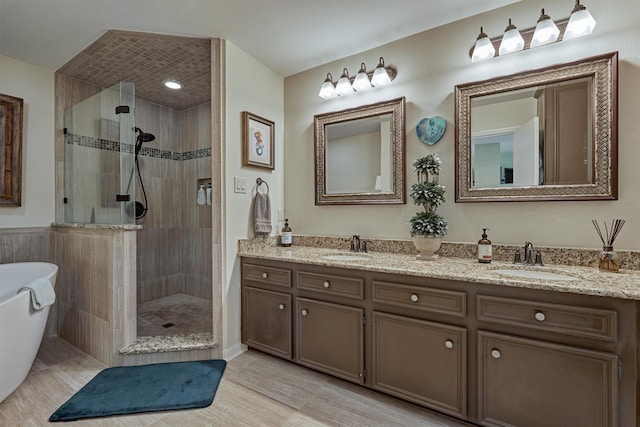 bathroom with vanity and independent shower and bath