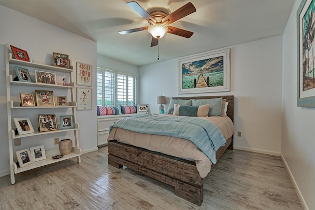 bedroom with ceiling fan and light wood-type flooring