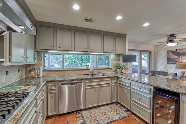 kitchen with sink, ceiling fan, light tile patterned floors, appliances with stainless steel finishes, and beverage cooler