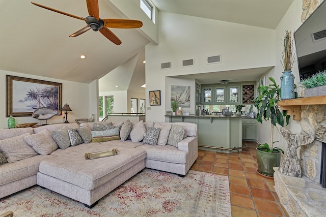 tiled living room featuring a wealth of natural light, high vaulted ceiling, and ceiling fan