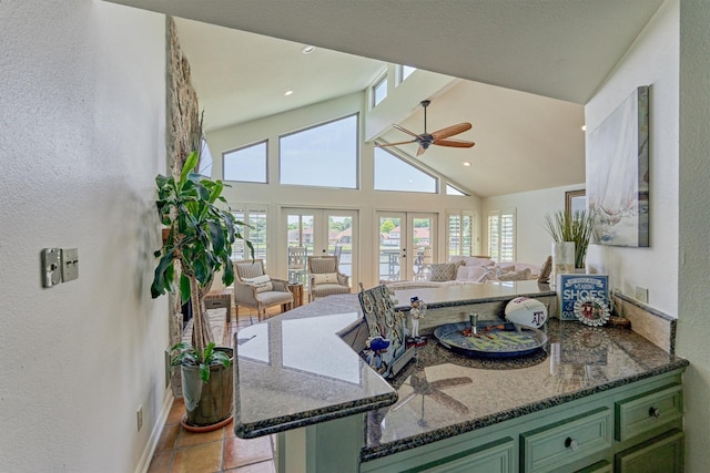 kitchen featuring french doors, green cabinetry, ceiling fan, dark stone countertops, and kitchen peninsula