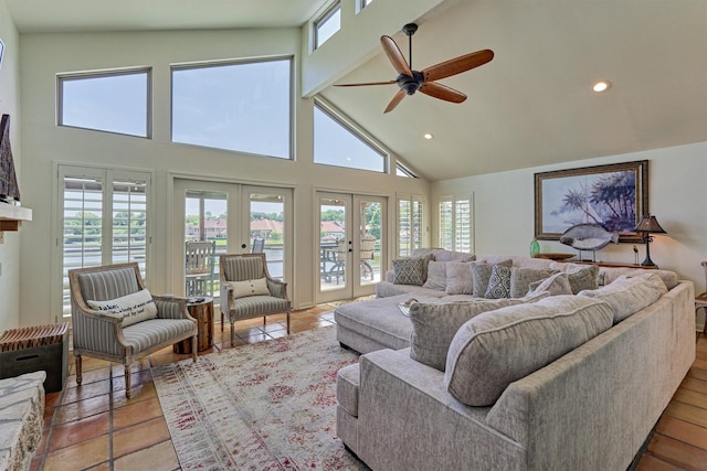 tiled living room featuring plenty of natural light, ceiling fan, high vaulted ceiling, and french doors