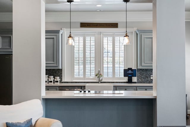 kitchen featuring dishwasher, sink, decorative backsplash, fridge, and decorative light fixtures