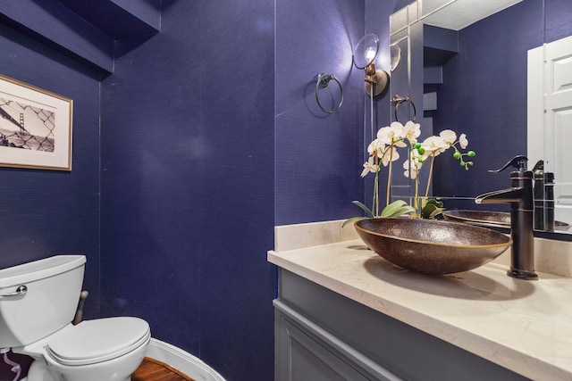 bathroom with hardwood / wood-style floors, vanity, and toilet