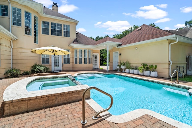 view of swimming pool with an in ground hot tub