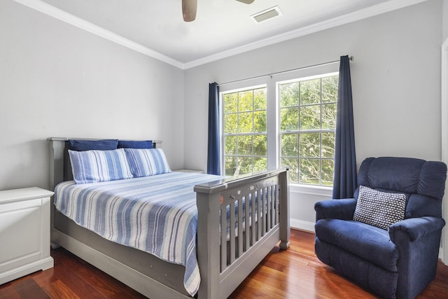 bedroom with ceiling fan, dark hardwood / wood-style flooring, crown molding, and multiple windows