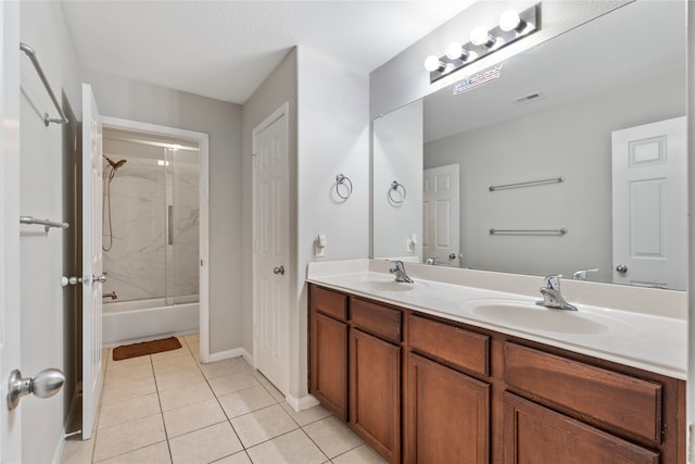 bathroom with tiled shower / bath, tile patterned flooring, and double vanity