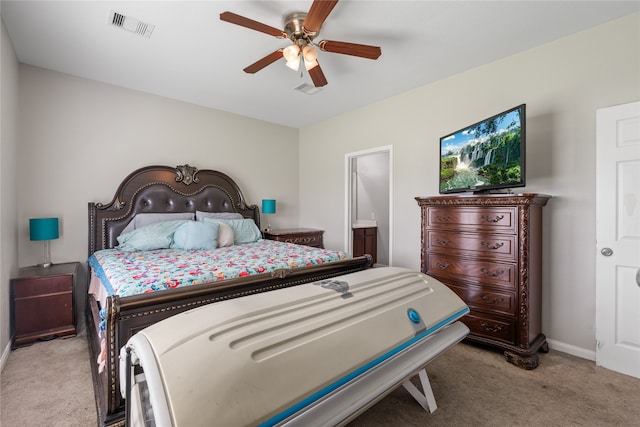 carpeted bedroom with connected bathroom and ceiling fan