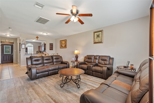 tiled living room with ceiling fan