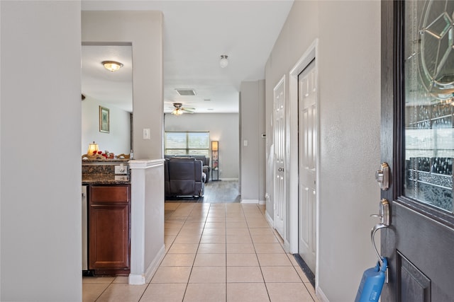 entryway with ceiling fan and light tile patterned floors