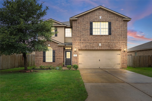 front of property with a garage and a yard