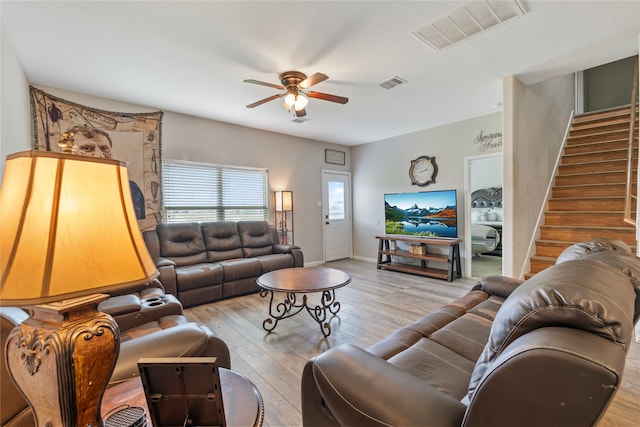 living room featuring light wood-type flooring and ceiling fan