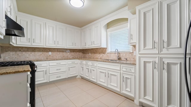 2715 Toyah Ave, Houston, TX 77039 - kitchen featuring tasteful backsplash, a sink, white cabinets, black gas range, and under cabinet range hood