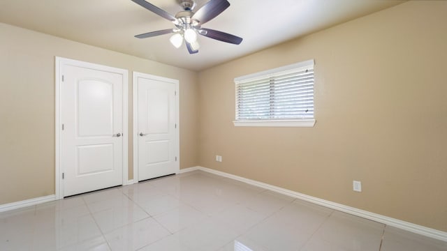 unfurnished bedroom featuring ceiling fan and light tile patterned floors