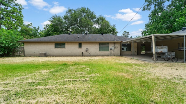 2715 Toyah Ave, Houston, TX 77039 - rear view of house with a yard, brick siding, central AC, and fence