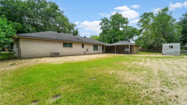 2715 Toyah Ave, Houston, TX 77039 - rear view of property with an outdoor structure, brick siding, a storage unit, central air condition unit, and a yard