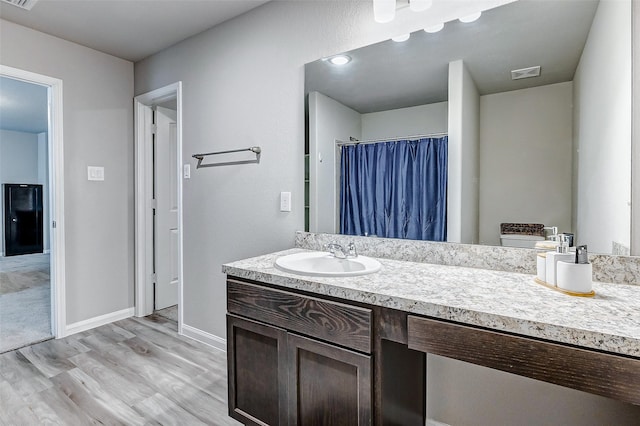 bathroom featuring vanity and wood-type flooring