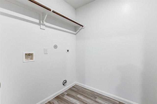 clothes washing area with hardwood / wood-style flooring, hookup for a washing machine, gas dryer hookup, and electric dryer hookup