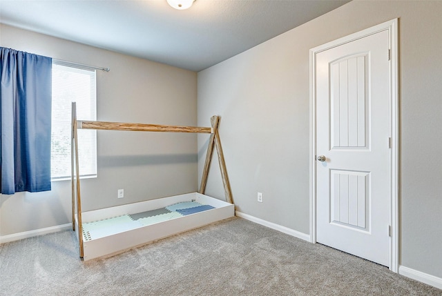 unfurnished bedroom with light colored carpet