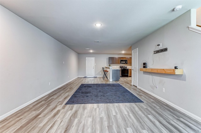 unfurnished living room featuring light wood-type flooring