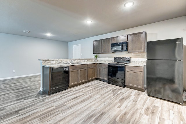 kitchen with black appliances, sink, kitchen peninsula, light hardwood / wood-style flooring, and dark brown cabinets