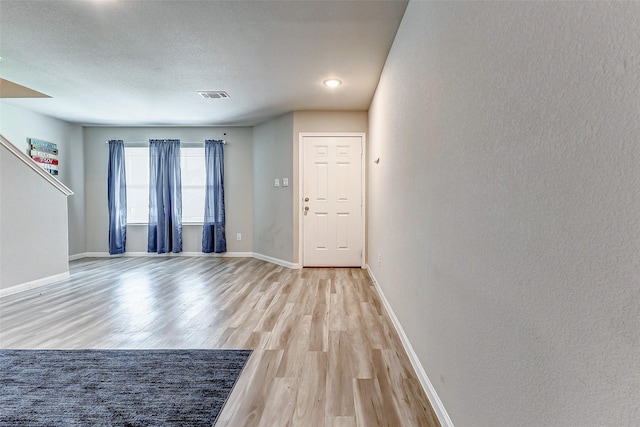 unfurnished room with light hardwood / wood-style floors