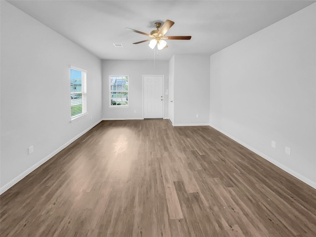 empty room featuring ceiling fan and dark hardwood / wood-style flooring