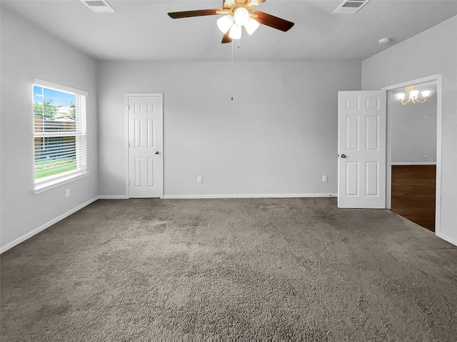 empty room with ceiling fan and dark carpet