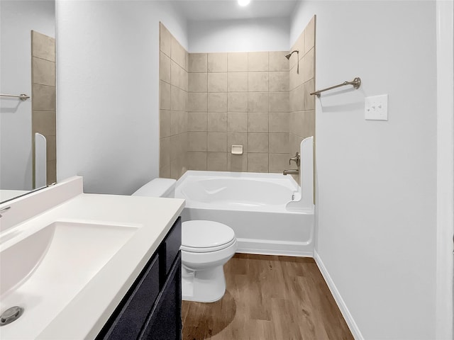 full bathroom with vanity, hardwood / wood-style floors, tiled shower / bath combo, and toilet