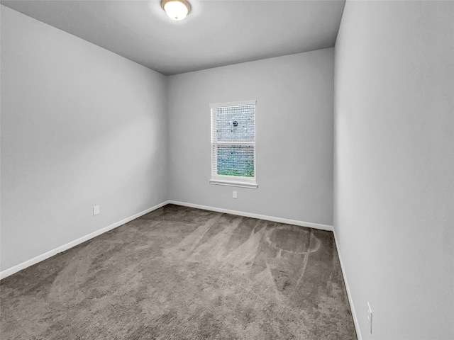 empty room featuring dark carpet