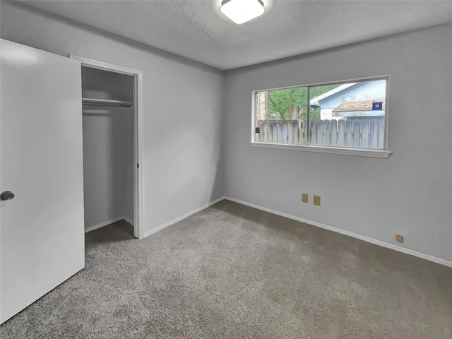 unfurnished bedroom with carpet and a closet