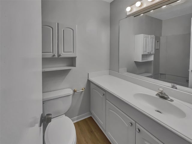 bathroom featuring hardwood / wood-style floors, toilet, and vanity