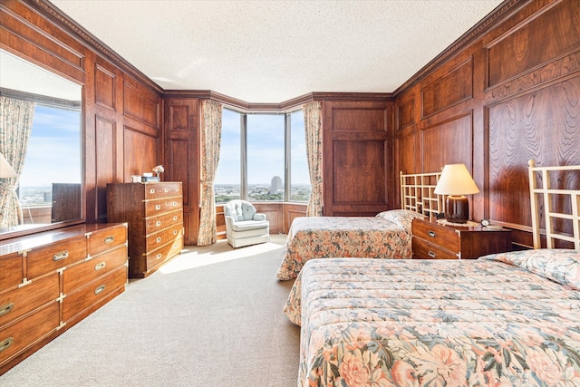 bedroom with light colored carpet, wooden walls, a textured ceiling, and ornamental molding