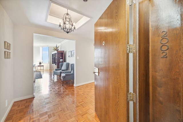 corridor featuring a chandelier and light parquet floors