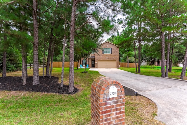 view of front of home featuring a garage and a front lawn