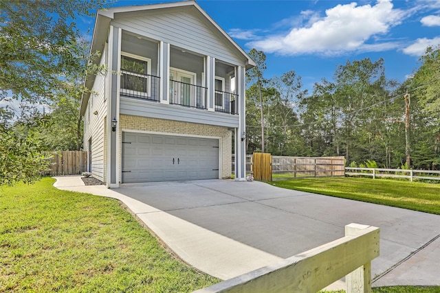 view of front of home with a garage, a balcony, and a front lawn