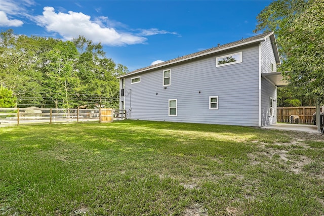 back of house with a lawn