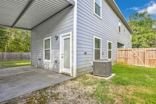 exterior space featuring a patio area, a yard, and central AC unit