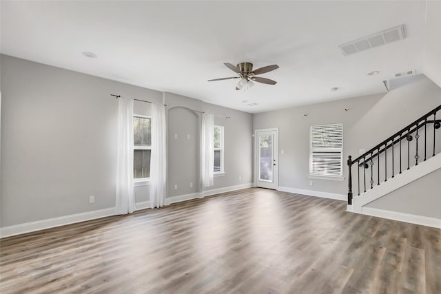 unfurnished living room featuring hardwood / wood-style floors and ceiling fan