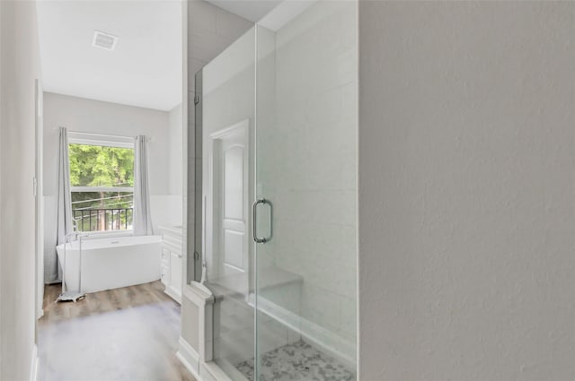 bathroom with shower with separate bathtub