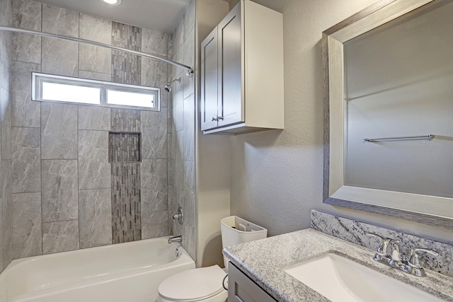 full bathroom featuring vanity, toilet, and tiled shower / bath