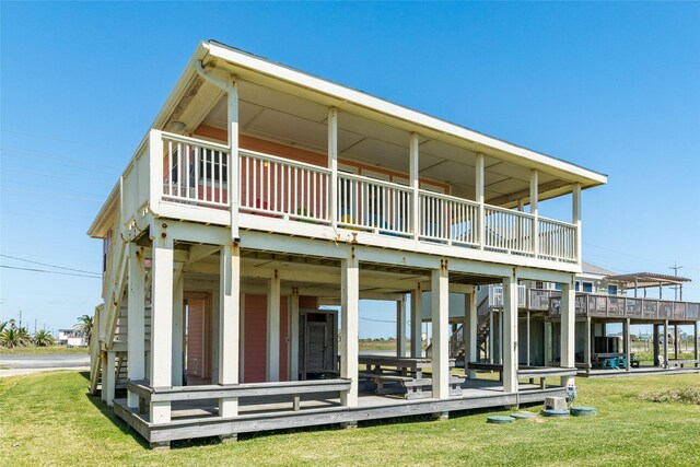 back of property with a lawn and a wooden deck