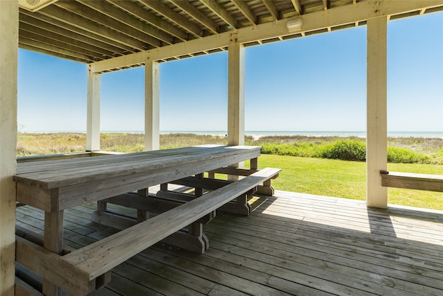 wooden deck featuring a water view and a yard