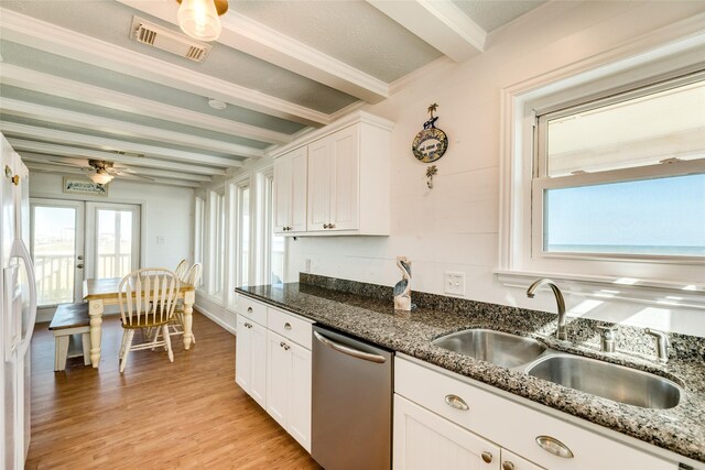 kitchen with white cabinets, beamed ceiling, light hardwood / wood-style floors, and stainless steel dishwasher