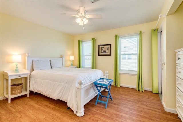 bedroom with light hardwood / wood-style floors and ceiling fan