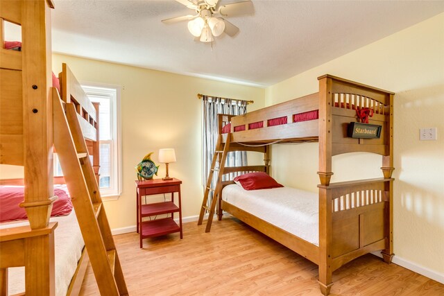 bedroom with light hardwood / wood-style floors and ceiling fan