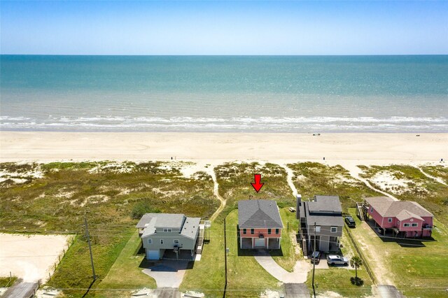 bird's eye view featuring a water view and a beach view