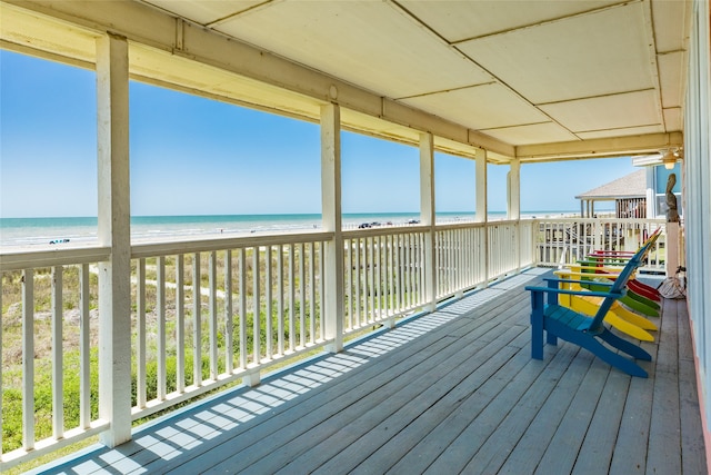 wooden terrace featuring a water view