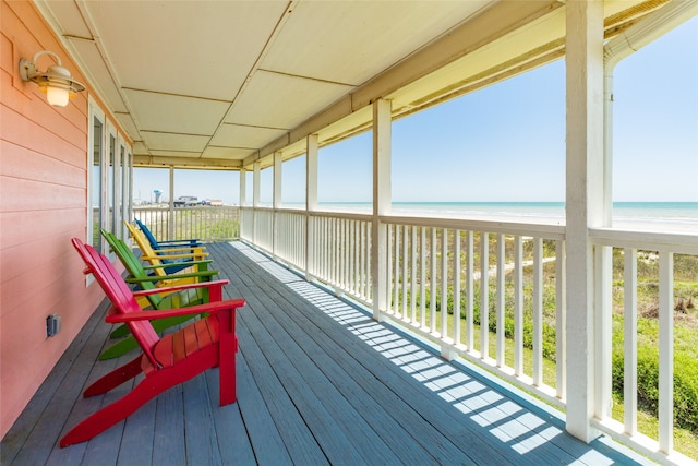 sunroom / solarium featuring a water view and a healthy amount of sunlight