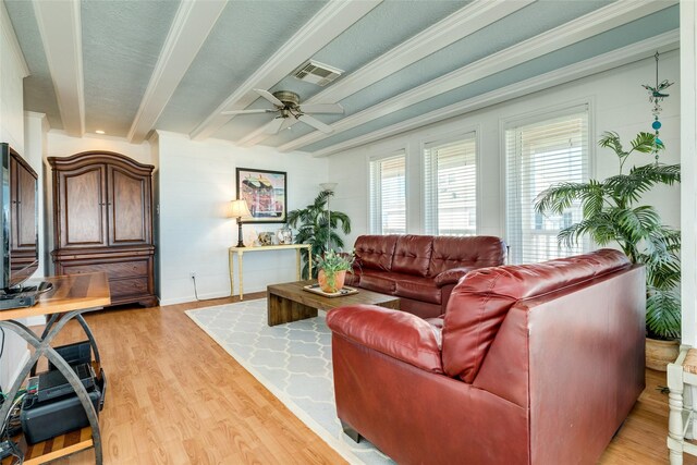 living room with light hardwood / wood-style floors, ornamental molding, beam ceiling, and ceiling fan